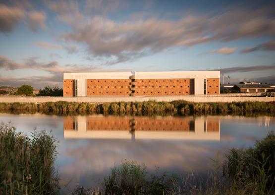 a building next to a body of water