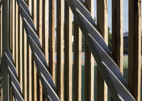 a wooden fence with shadows on it