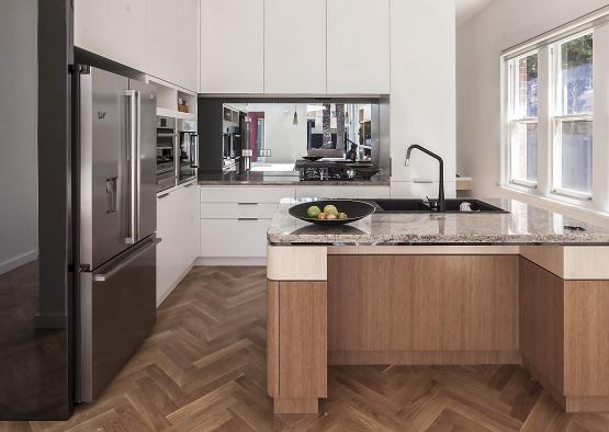 a kitchen with a sink and a stainless steel refrigerator