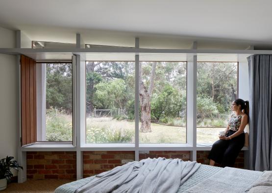 a woman sitting on a window sill