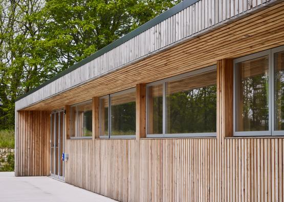 a building with a wood wall and windows