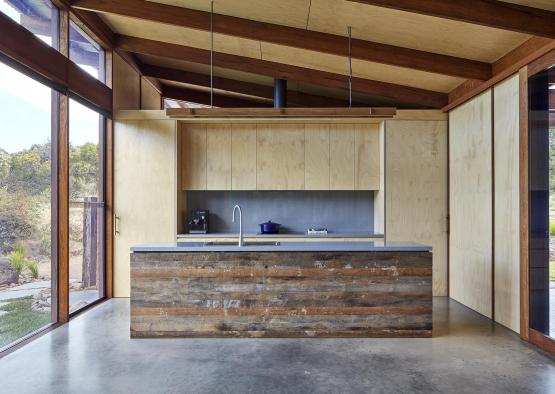 a kitchen with a wood island and a large window