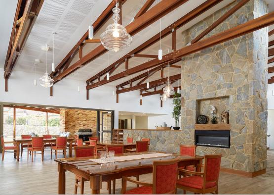 a room with a stone fireplace and tables