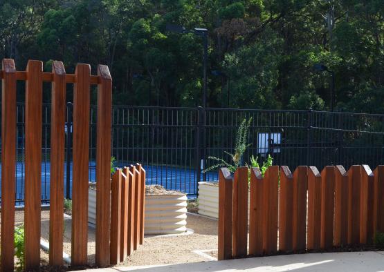 a fenced in area with trees in the background