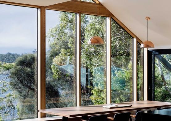 a dining table with chairs and a large window