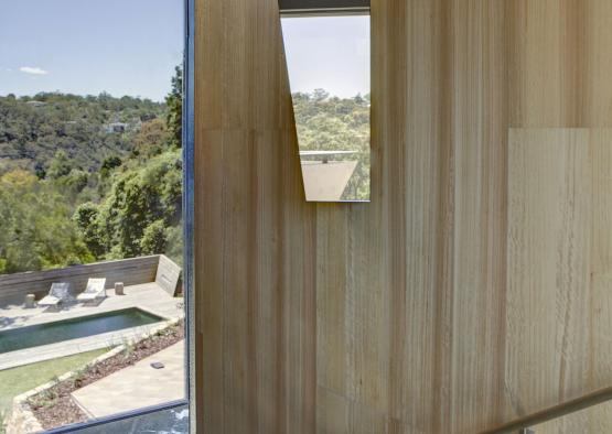 a view of a pool from a window of a house