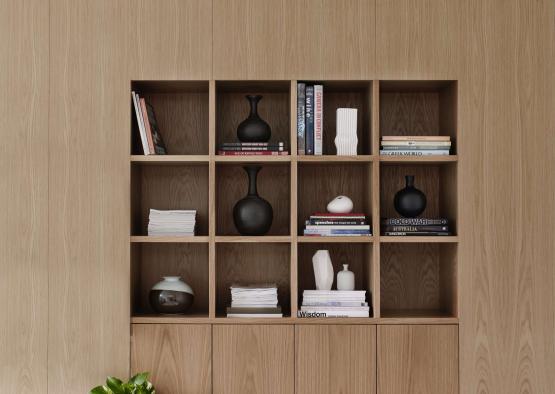 a shelf with books and vases on it