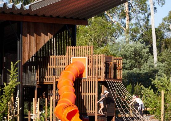 a playground with a slide and a net