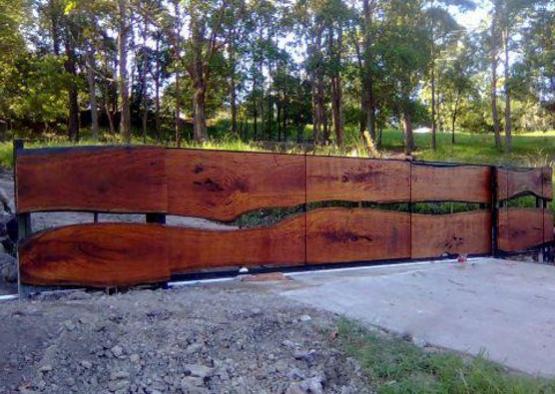 a wood fence with trees in the background