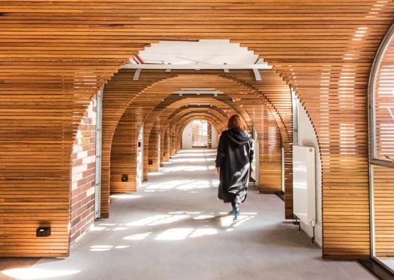 a woman walking in a hallway