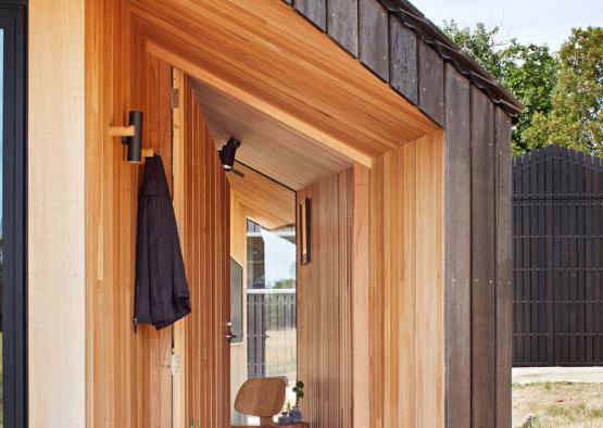 a wooden house with a chair and a chair