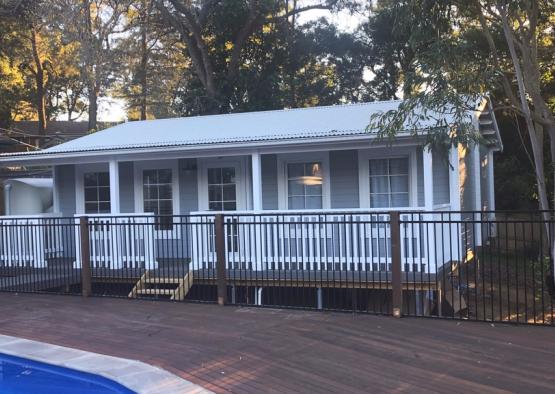 a house with a fence and trees