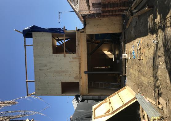 a building under construction with a blue tarp