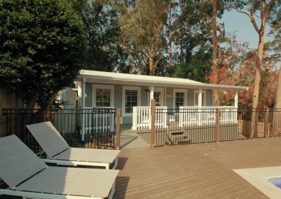 a deck with chairs and a fence