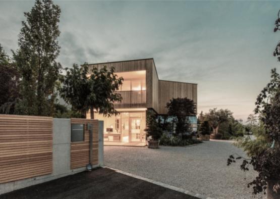 a building with a driveway and trees