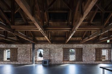 a room with brick walls and wooden beams