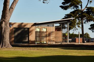 a building with a roof and a tree