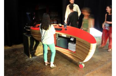 a woman standing in front of a desk