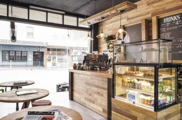 a coffee shop with a counter and a glass case