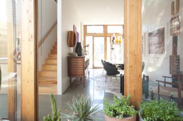 a room with a wood staircase and a wood cabinet