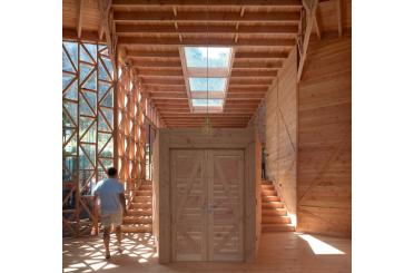 a man walking in a wooden building