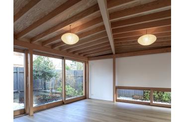 a room with wood beams and ceiling and glass doors