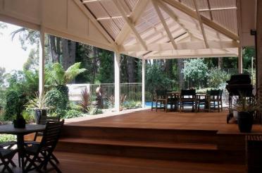 a patio with a deck and chairs