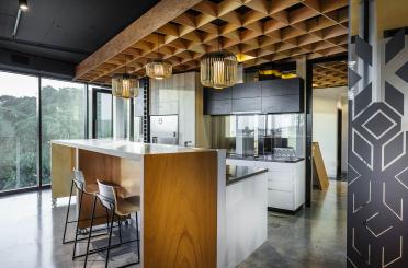 a kitchen with bar stools and lights