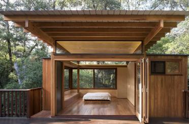 a wooden house with a bed